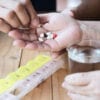 Doctor is assist patient to eat medicine tablet in pillbox correctly